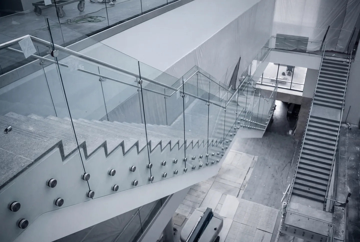 A glass stair railing going in on a job site