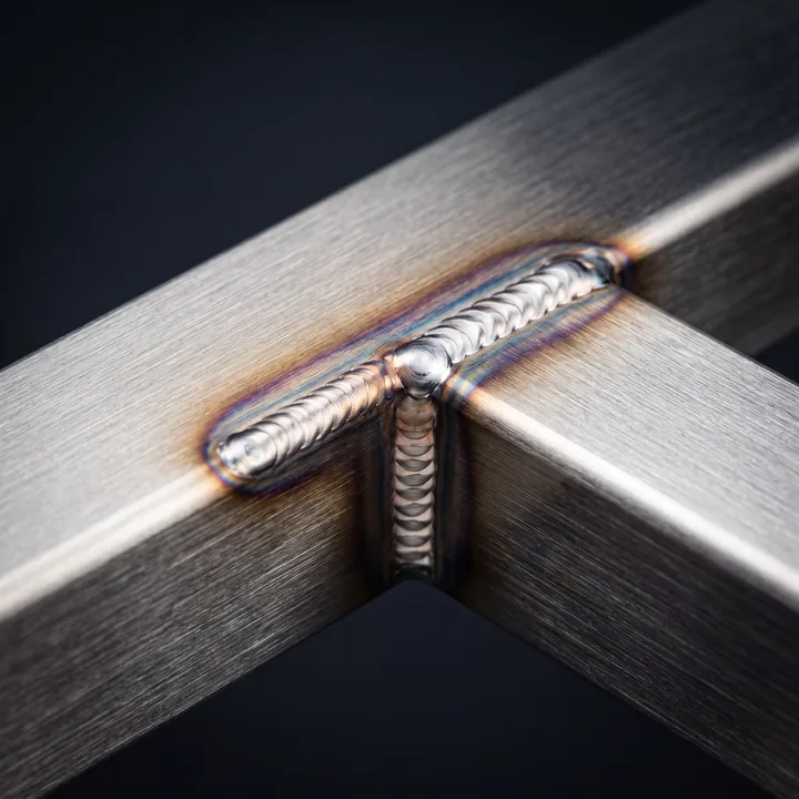 Close-up of a clean weld on brushed steel